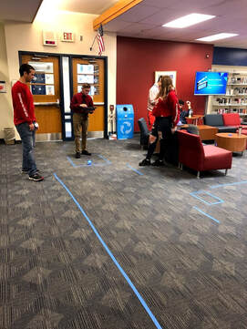 Picture Students using Sphero Robots with  iPads on a course
